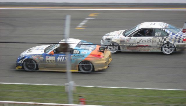 The #333 H.I.S. NISMO Z alongside BMW M3 competing in the same class.