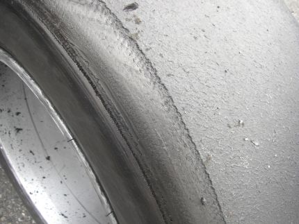 Damaged tire from a component failure due to downforce/debris