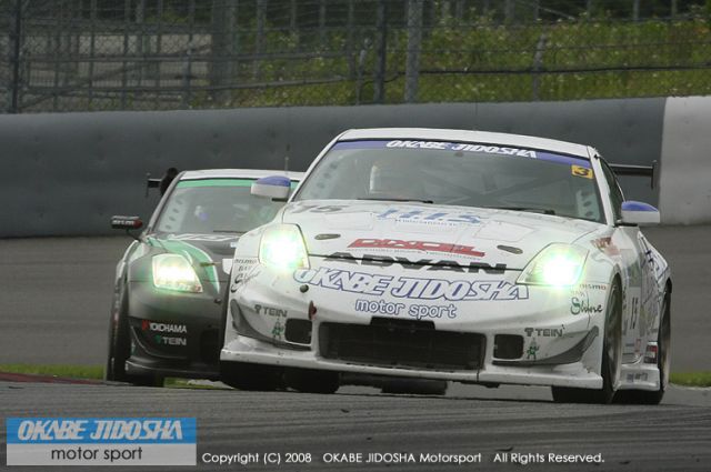 Igor Sushko in the #15 Okabe Jidosha Dixcel Nissan Z after passing the #113 Nissan Z for 3rd place, having come up from 8th.